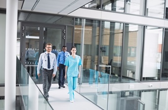 Doctors and nurse walking in corridor at hospital