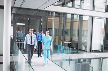 Doctors and nurse walking in corridor at hospital